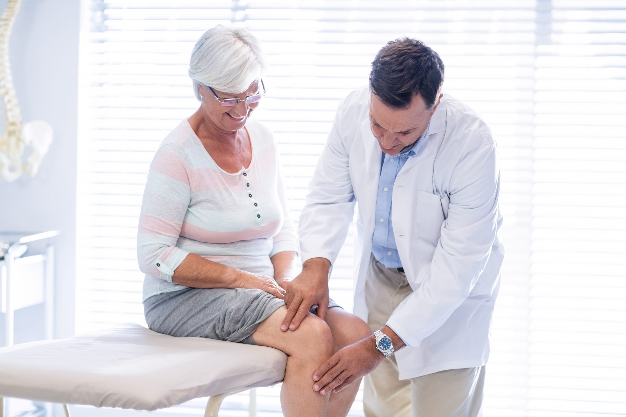 Happy joint pain patient receiving treatment.